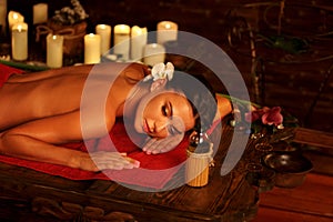 Massage of woman in spa salon. Luxary interior oriental therapy .