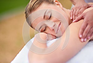 Massage, woman and spa for therapy, wellness and relaxation in muscles, back and neck for self care. Female person