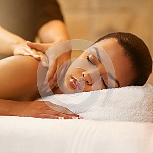 Massaging the body and mind. a young woman getting a massage at the spa.