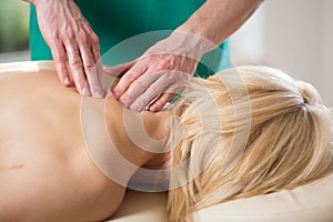 Massaging tense vertebral muscles photo