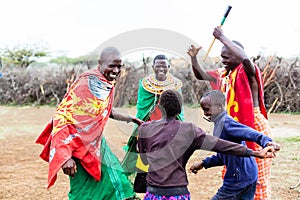 Massai family celebrating and dancing