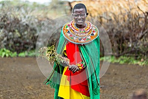 Massai woman standing in her village