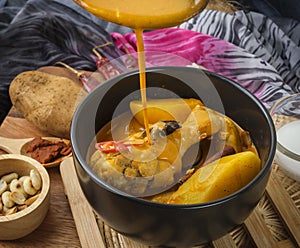 Massaman Curry With Chicken and Thai herbs with wood background texture