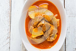 Massaman pork curry on wood background. Coconut milk curry.