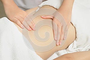 Masseur applying massage techniques to relax back muscles photo