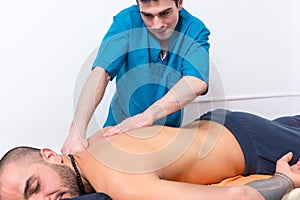 Masseur doing a back massage on a client
