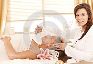 Masseur doing head massage photo