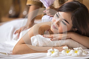 Masseur doing massage on asia woman body photo