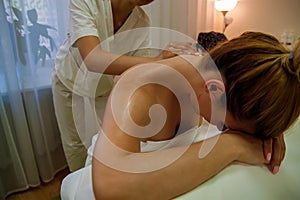 Masseur Doing Massage On Back. Woman Receiving Back Massage.