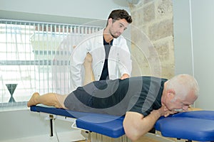 masseur doing massage on man back