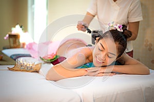 Masseur doing massage spa with treatment mud on Asian woman body in the Thai spa lifestyle, so relax and luxury.