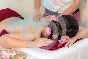 Masseur doing massage spa with treatment salt and sugar on Asian woman body in the Thai spa lifestyle, so relax and luxury.