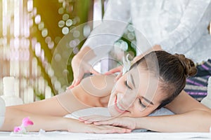 Masseur doing massage on  woman body in the spa salon, Asian woman on massage bed relax and lifestyle, massage hands treatment.