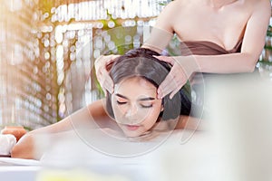 Masseur doing massage on  woman body in the spa salon, Asian woman on massage bed relax and lifestyle, massage hands treatment.