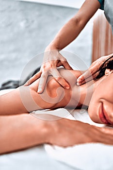 Masseur doing massage on woman body in the spa salon. Beauty treatment concept