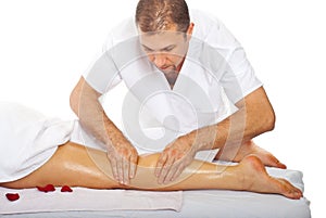 Masseur giving anti cellulite leg massage photo