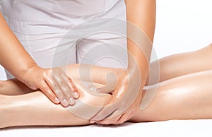 Masseur makes anti-cellulite massageon the legs, thighs, hips and buttocks in the spa. Overweight treatment, body sculpting.