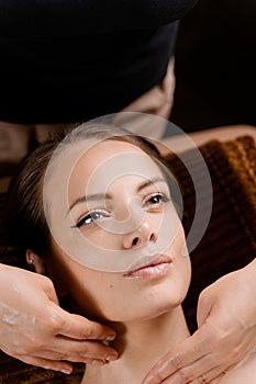 Masseur is making facial massage in spa for model with perfect skin. Beauty procedure.
