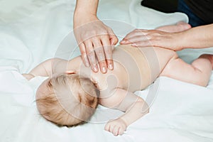 Masseur massaging a child baby