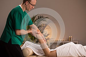 Masseur massaging lower limb