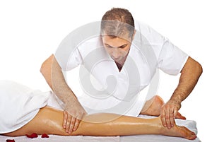 Masseur massaging woman's leg photo