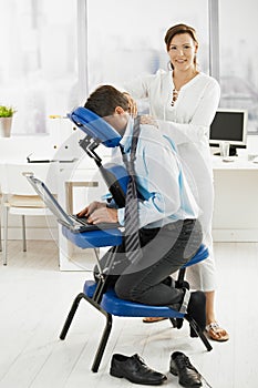 Masseur working in office photo