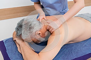 masseuse doing back massage to middle