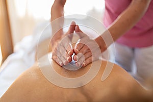 Masseuse doing massage with hands in recovery center