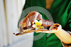 Masseuse holding spa ingredients