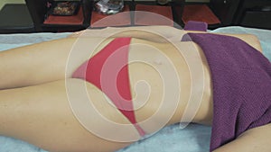 Masseuse make remedial massage of head to young slim woman in saloon. Relaxing