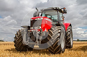 Massey Ferguson 7726 parked up on stubble in crop field