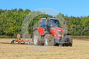 Massey Ferguson 7726 ploughing on stubble in crop field