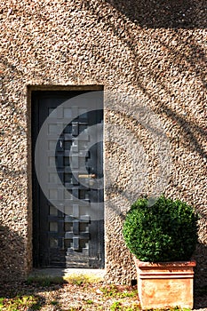 Massive antique outside wooden door of a chateau, castle with many small square windows