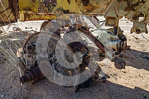 Massive axle of abandoned harvester rusting away deep in the Namib Desert of Angola