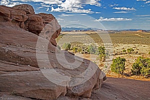 Massive boulders frame a scenic landscape in Monument Valley.