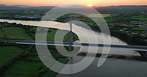 The massive cable-stayed bridge over the Suir River against the sunset 4k