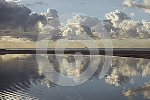 Massive Clouds reflected in blue lagoon