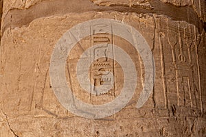 Massive columns inside beautiful Egyptian temple in Luxor with hieroglyphics, and ancient symbols. Karnak temple