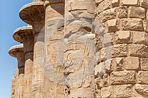 Massive columns after reconstruction inside beautiful Egyptian temple in Luxor with hieroglyphics, and ancient symbols. Karnak