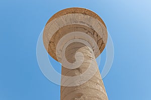 Massive columns after reconstruction inside beautiful Egyptian temple in Luxor with hieroglyphics, and ancient symbols. Karnak