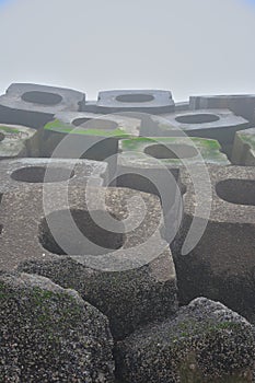 Massive concrete blocks of a storm breaker at the beach
