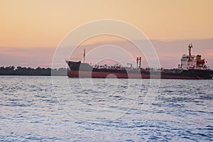 Massive container ship for import export and business logistic. Big cargo ship is leaving from Bangkok Port Authority of Thailand