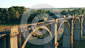 Massive deserted bridge with a woman running along it