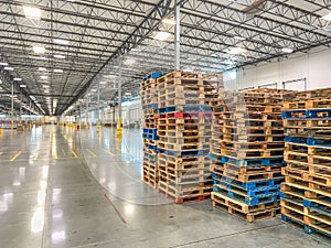 Massive Empty Industrial Warehouse Interior With Stacked Pallets