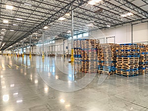 Massive Empty Industrial Warehouse Interior With Stacked Pallets