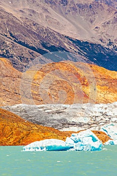 Massive glacier descends into emerald water