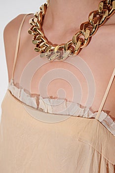 Massive golden chain on girls neck.