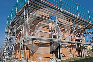 Massive home in shell construction with scaffolding