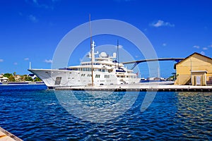 Massive luxury yacht docked near bridge on Curacao