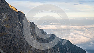 Massive mountain ridge towering above the clouds and catching the last light, Slovakia, Europe